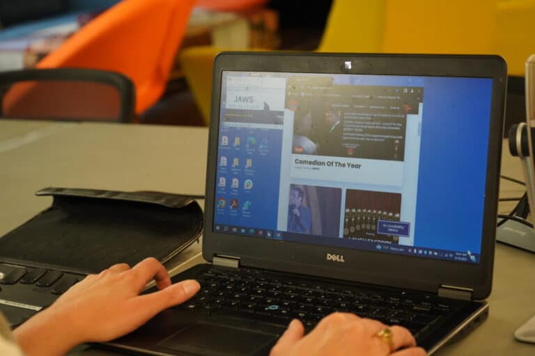 Kristen, a person who is blind, uses the screen reader software Jaws while attempting to use a website overlay.