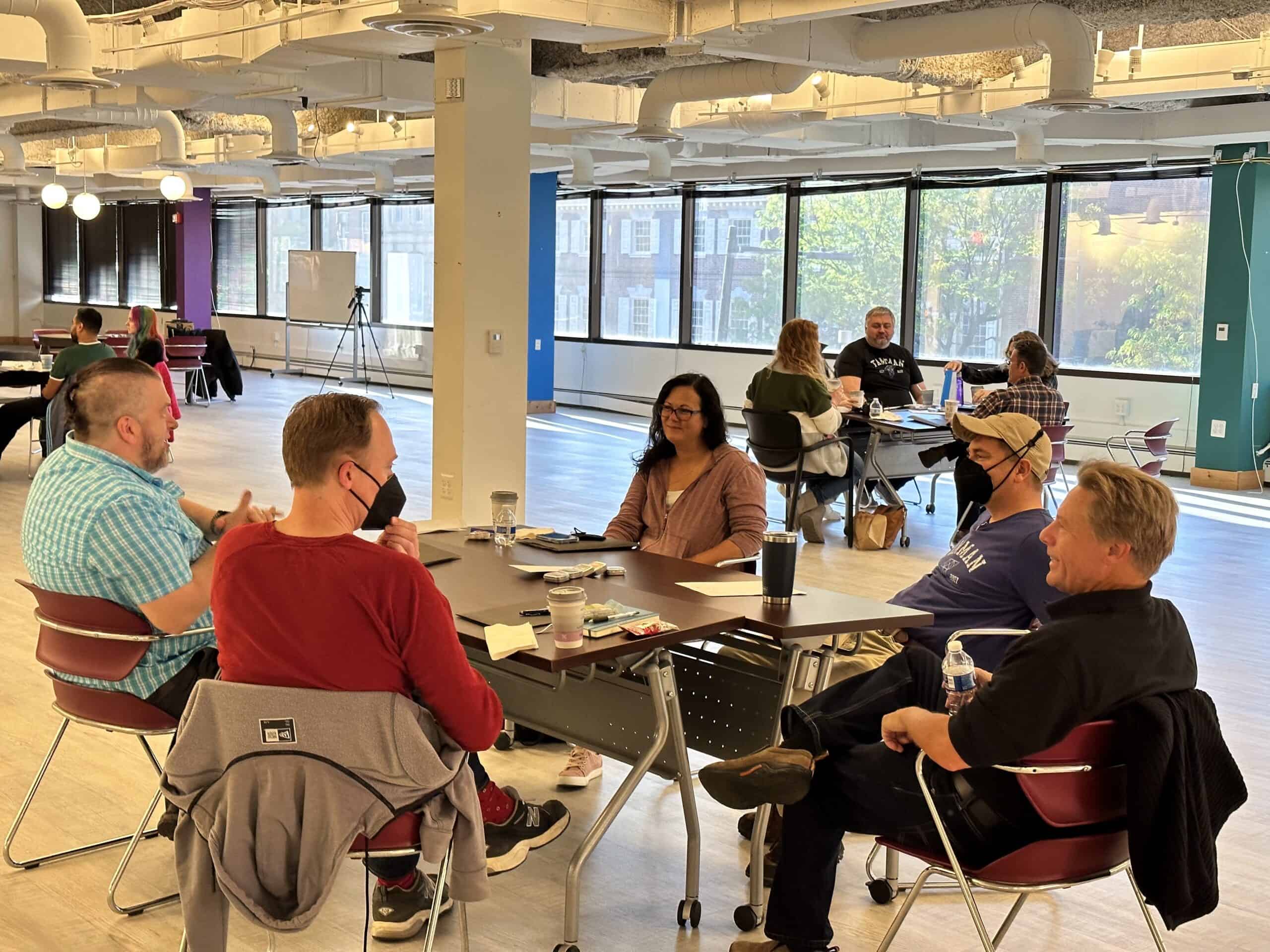 Marty sits down at a conference with some of our Mac Engineering team to catch up and talk about their itinerary for the day.