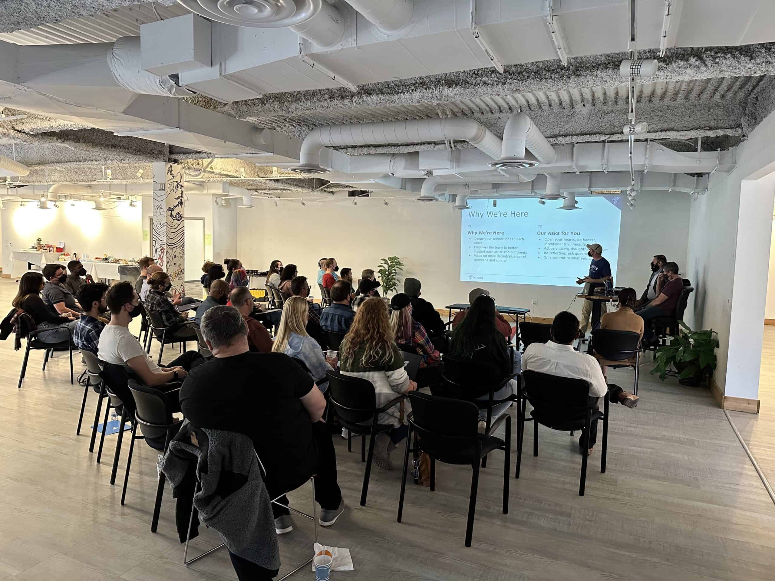 Tamman President Marty Molloy addresses a large crowd of Tamman employees with a warm welcome.