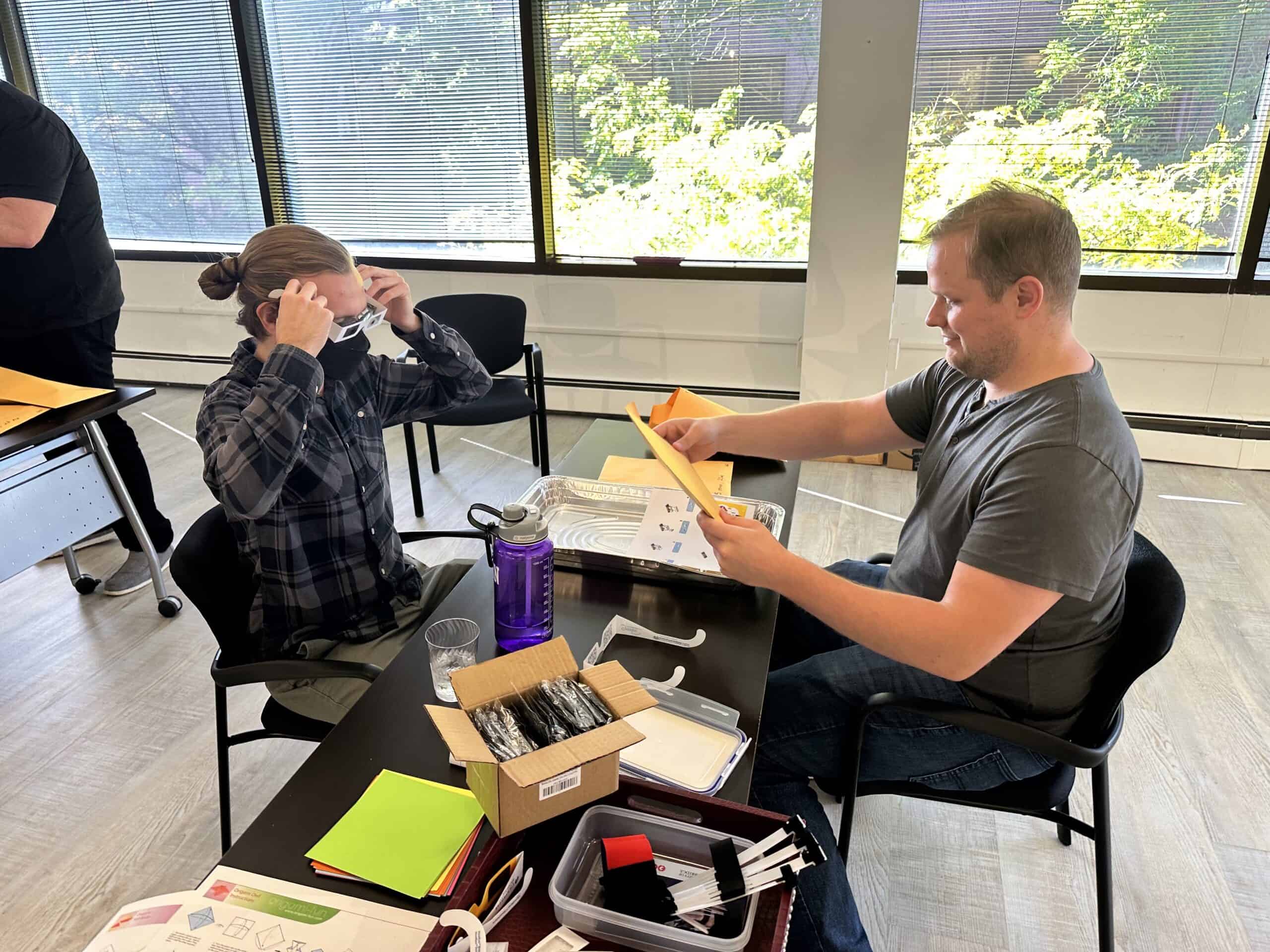 James and Cameron sit down and attempt to construct a small Lego set. James gives Cameron instructions while Cameron wears glasses that simulate a visual disability.