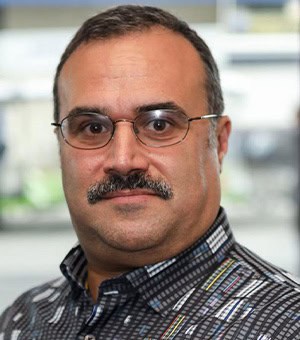 A headshot of Leonard Rosenthol wearing his glasses and a patterned button down shirt. 