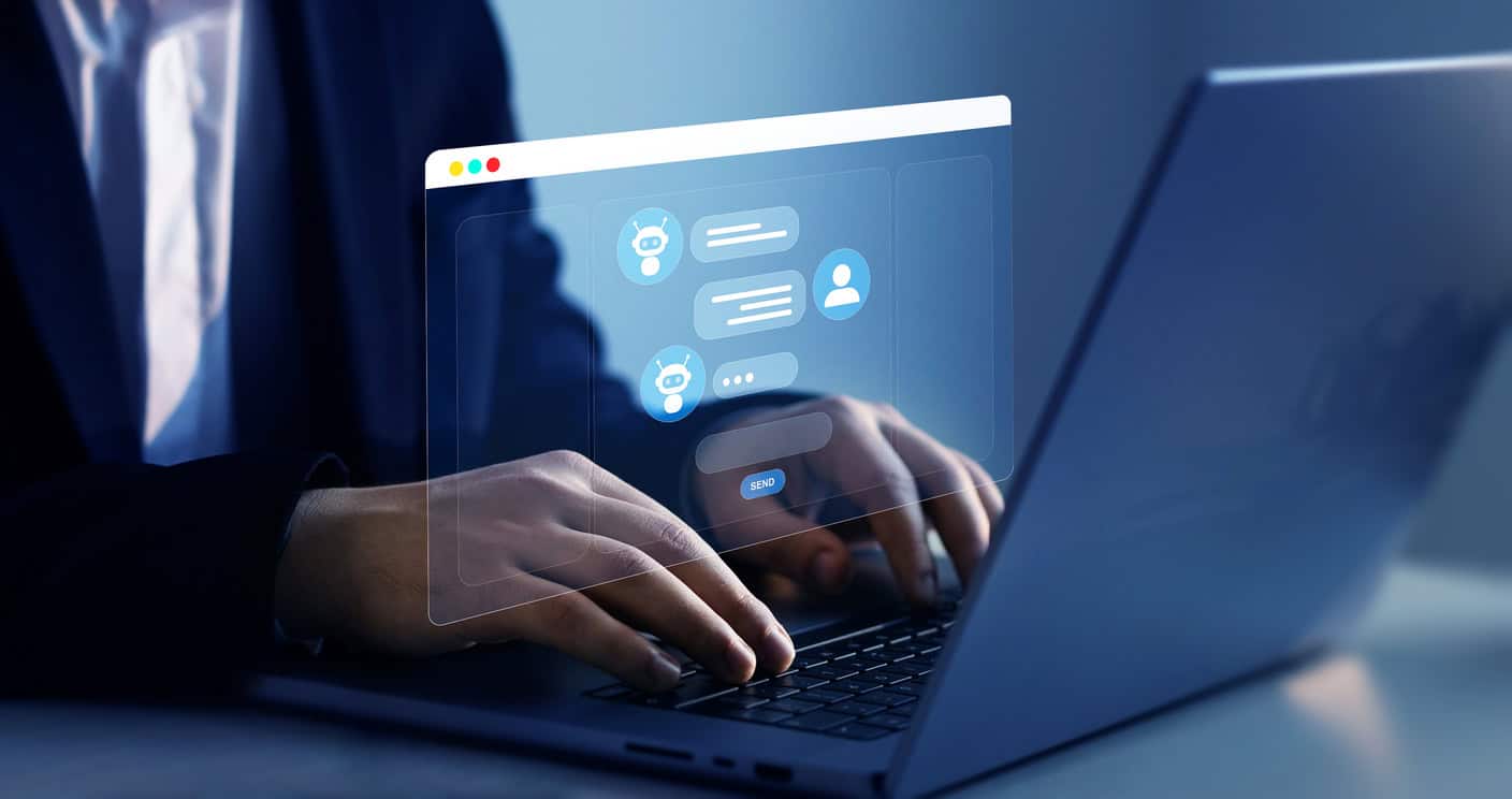 A person sitting at a computer chatting with someone on messenger. The chat looks holographic coming off the screen.