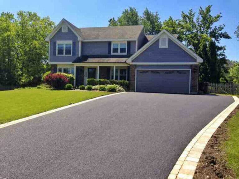 A perfectly paved driveway in front of a two-story home