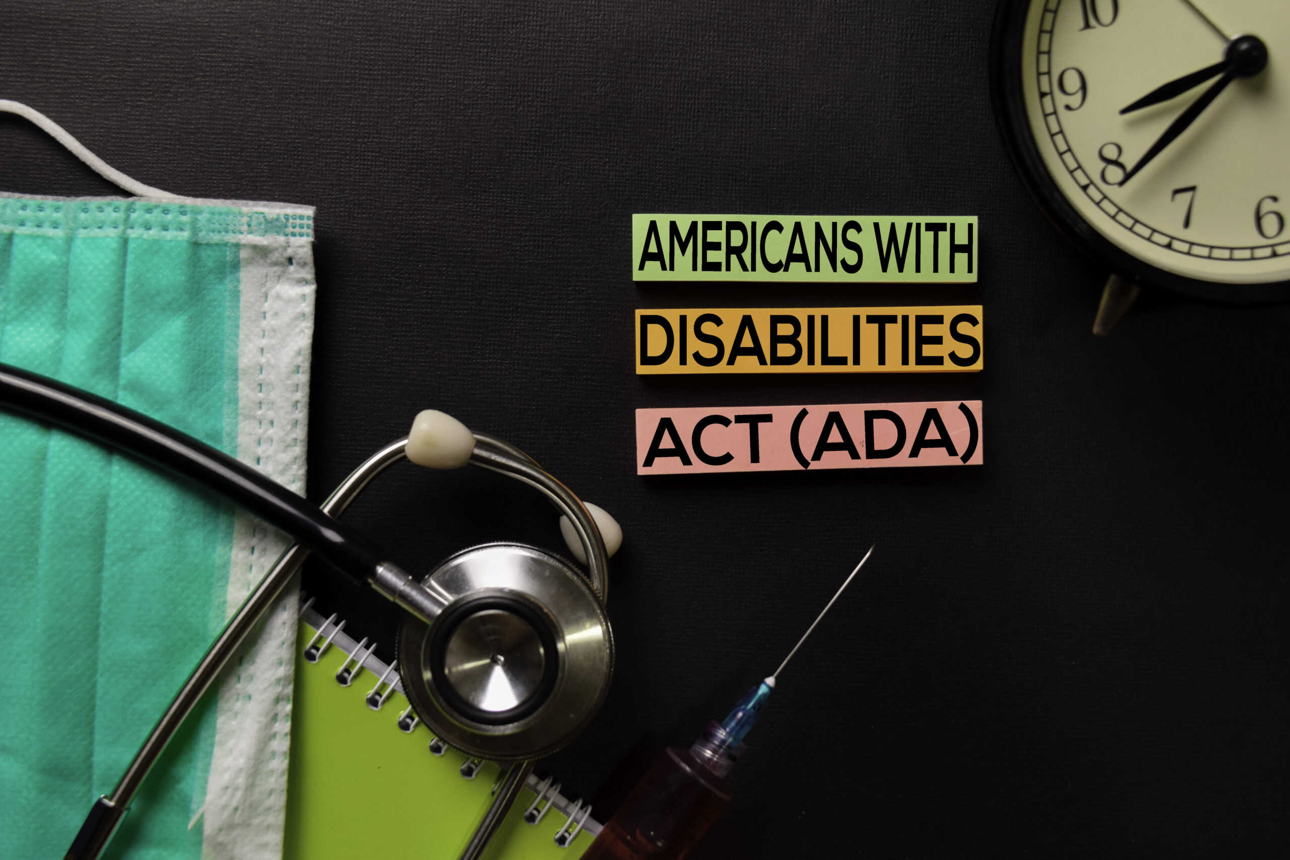Americans with Disabilites Act (ADA) text on top view black table with blood sample and Healthcare/medical concept.
