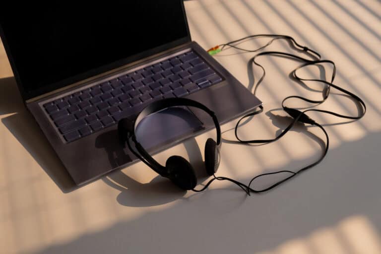 Headphones connected to a laptop computer.