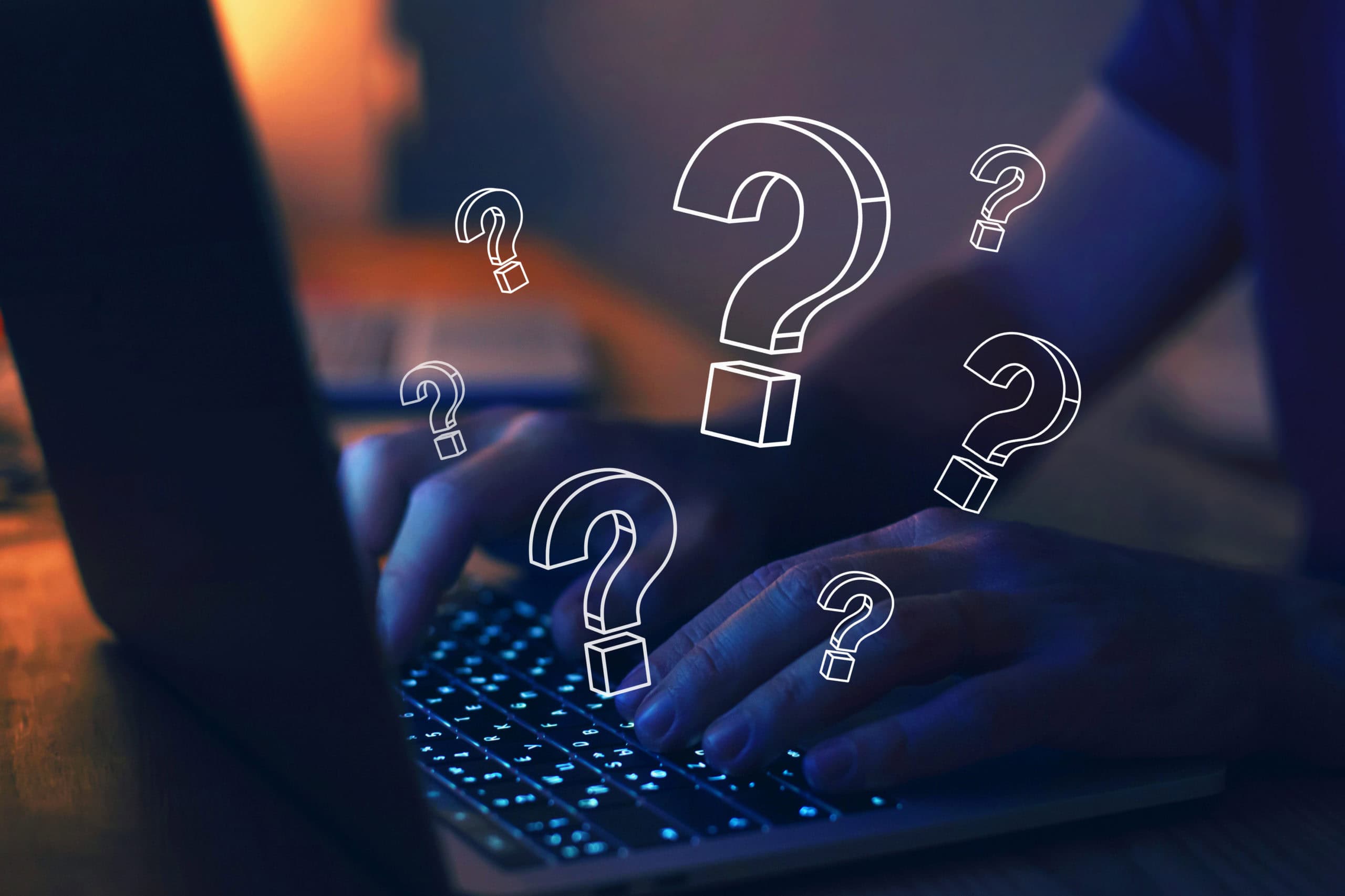Fingers on laptop keyboard with superimposed question marks all over the image