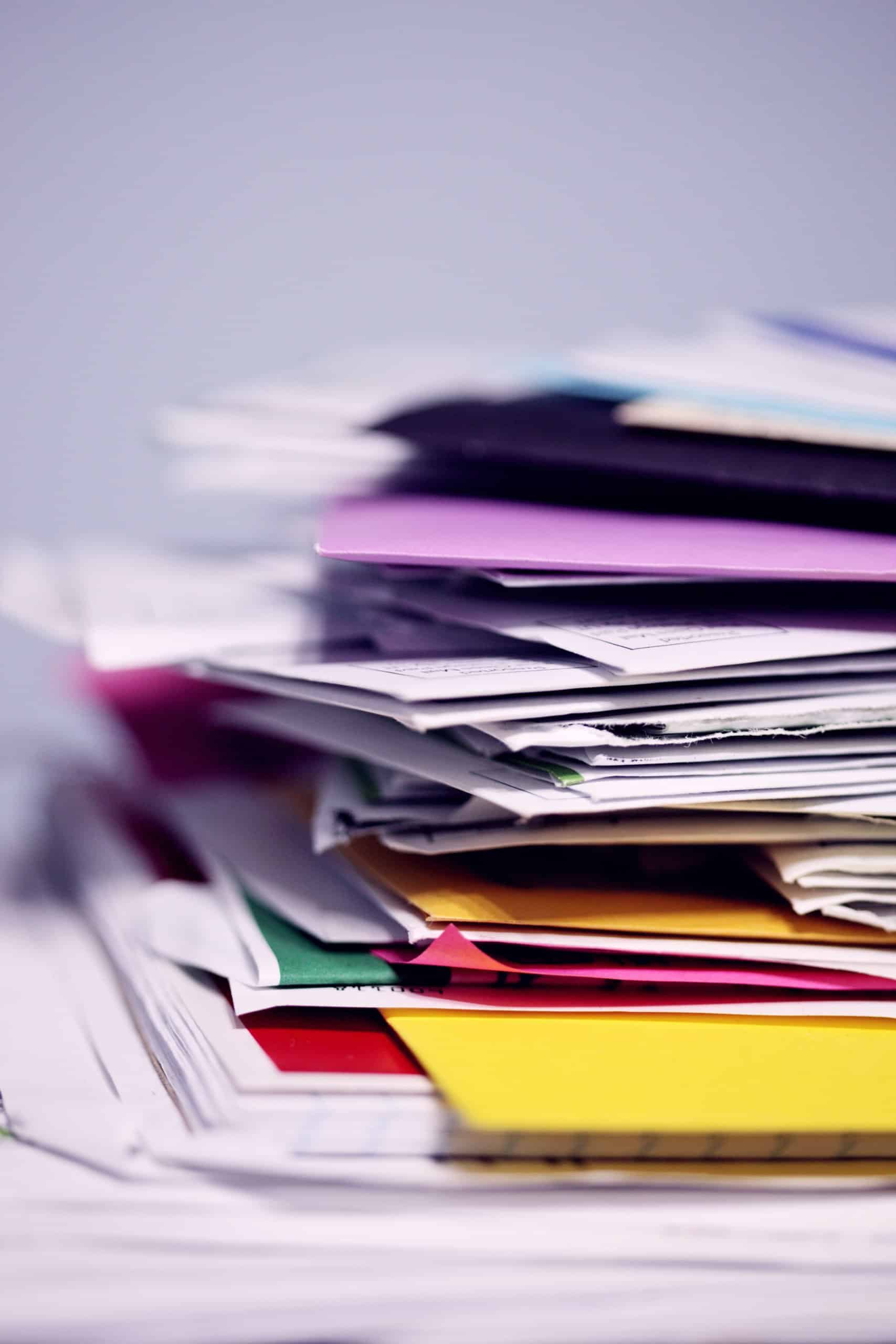 Messy multi-colored pile of folders and documents